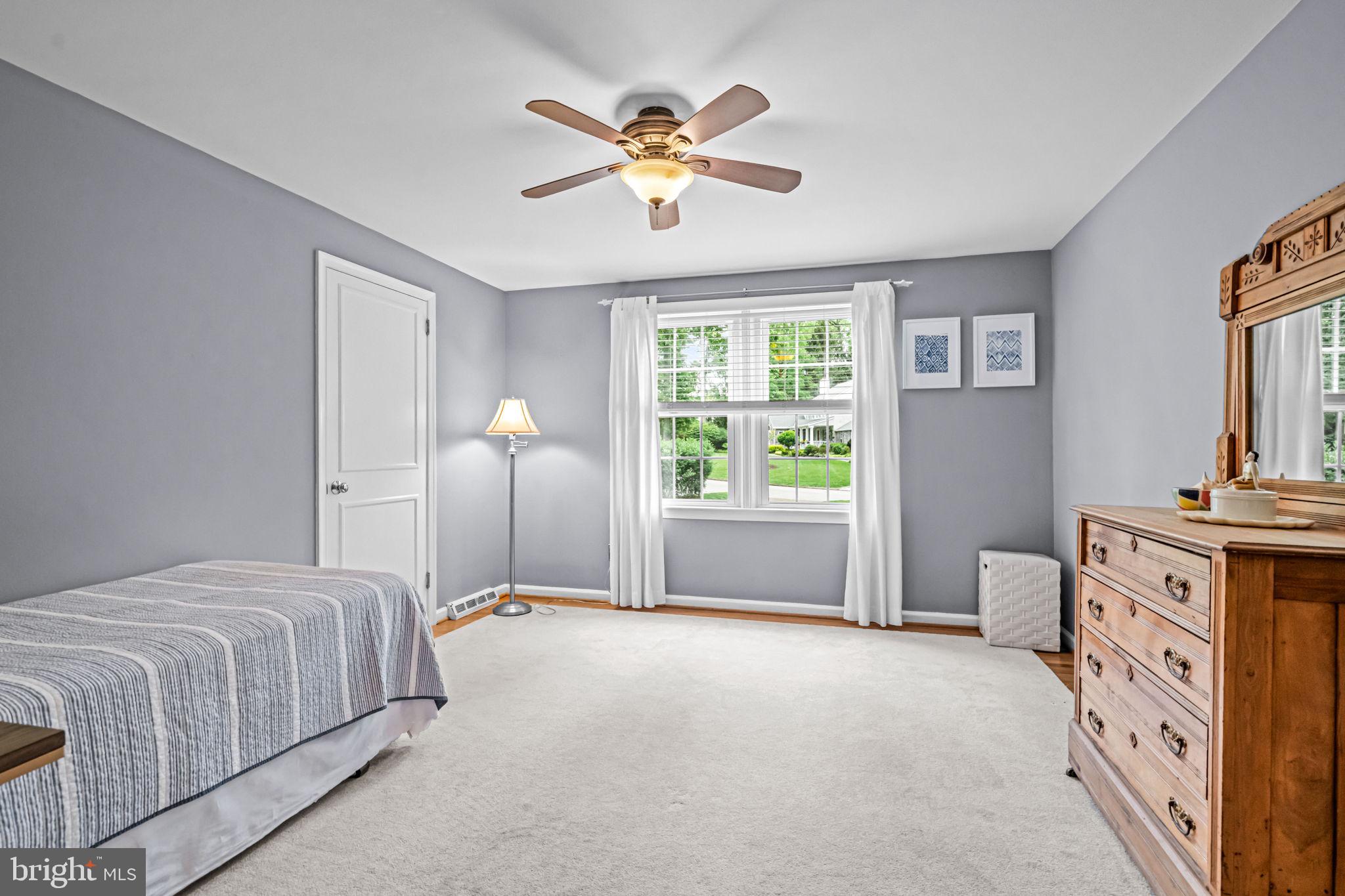 363 Colket Lane Wayne, PA 19087 - Photo 37 of 52 a spacious bedroom with a bed and a chandelier