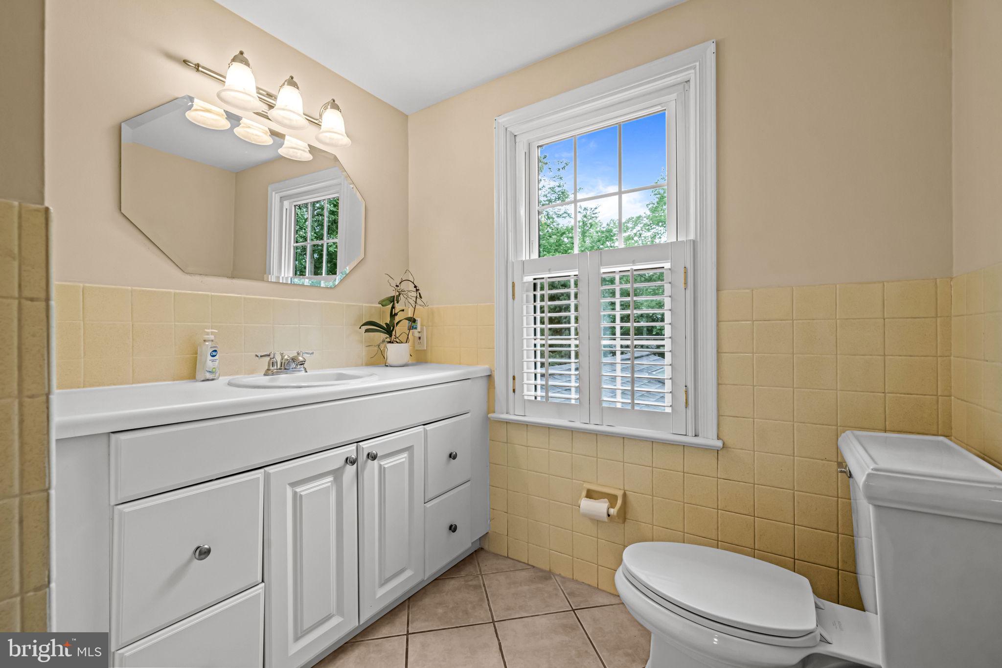 363 Colket Lane Wayne, PA 19087 - Photo 40 of 52 a bathroom with a toilet a sink a mirror a window and vanity