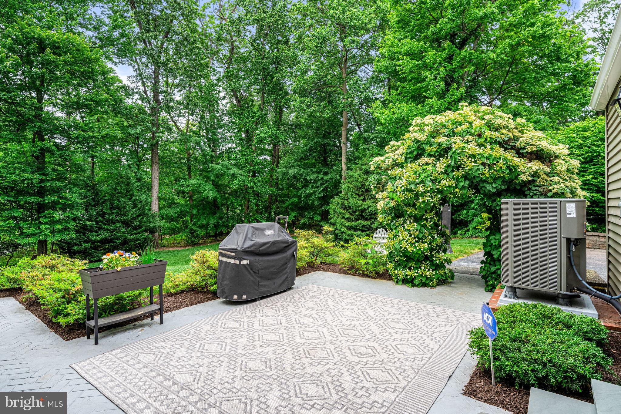363 Colket Lane Wayne, PA 19087 - Photo 47 of 52 a view of a garden with plants and a bench