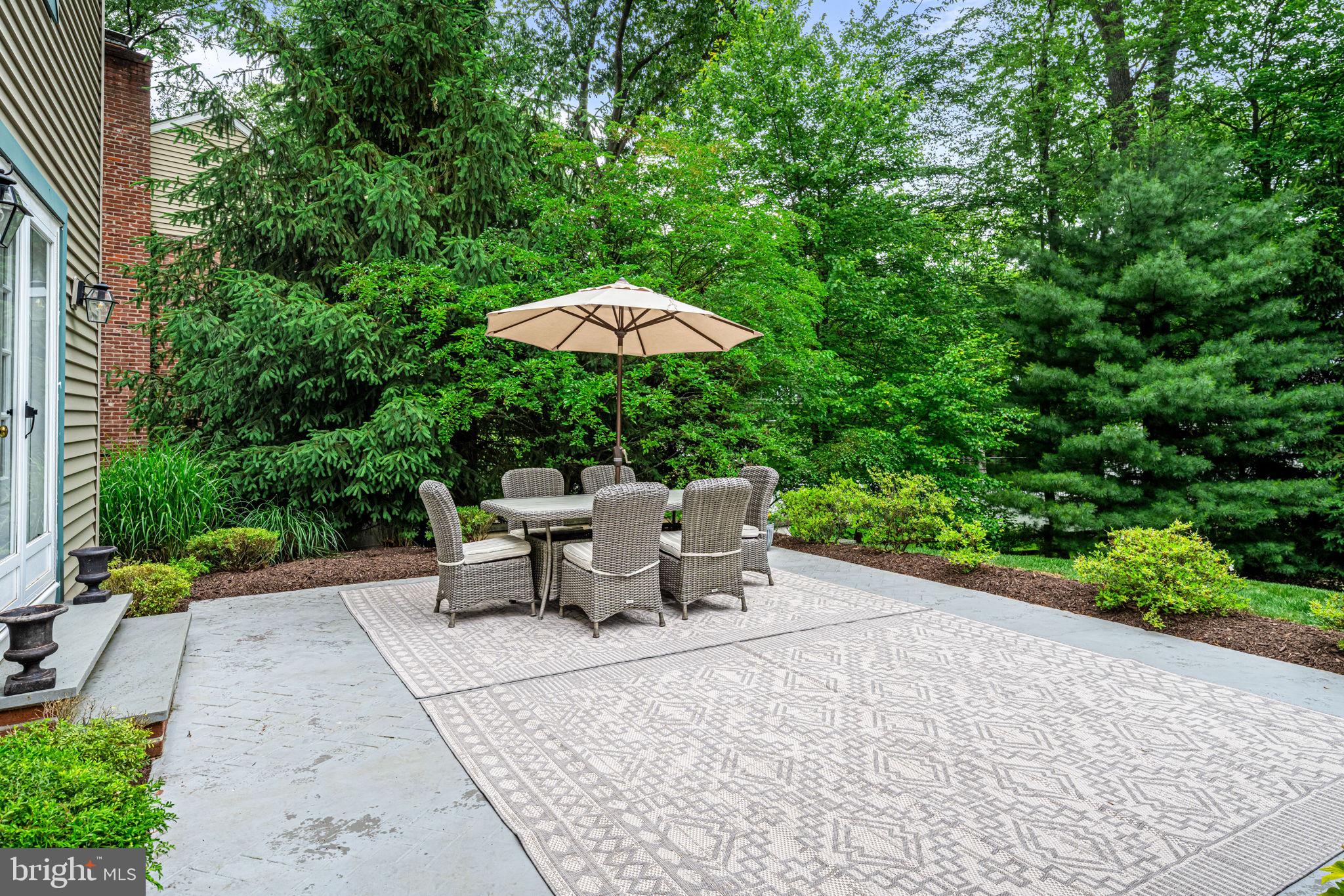 363 Colket Lane Wayne, PA 19087 - Photo 48 of 52 a view of a patio with table and chairs under an umbrella