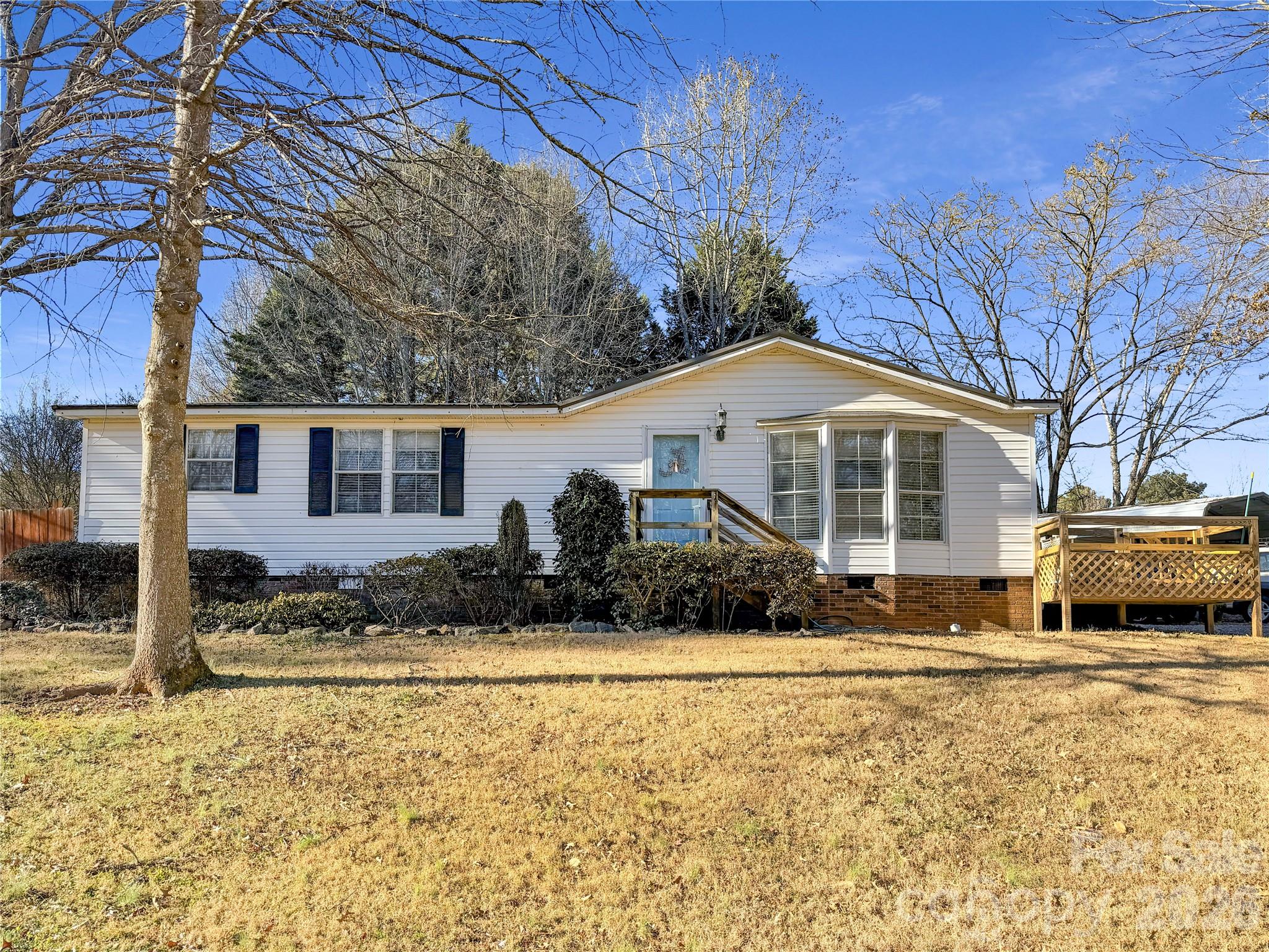 a front view of a house with a yard covered in snow