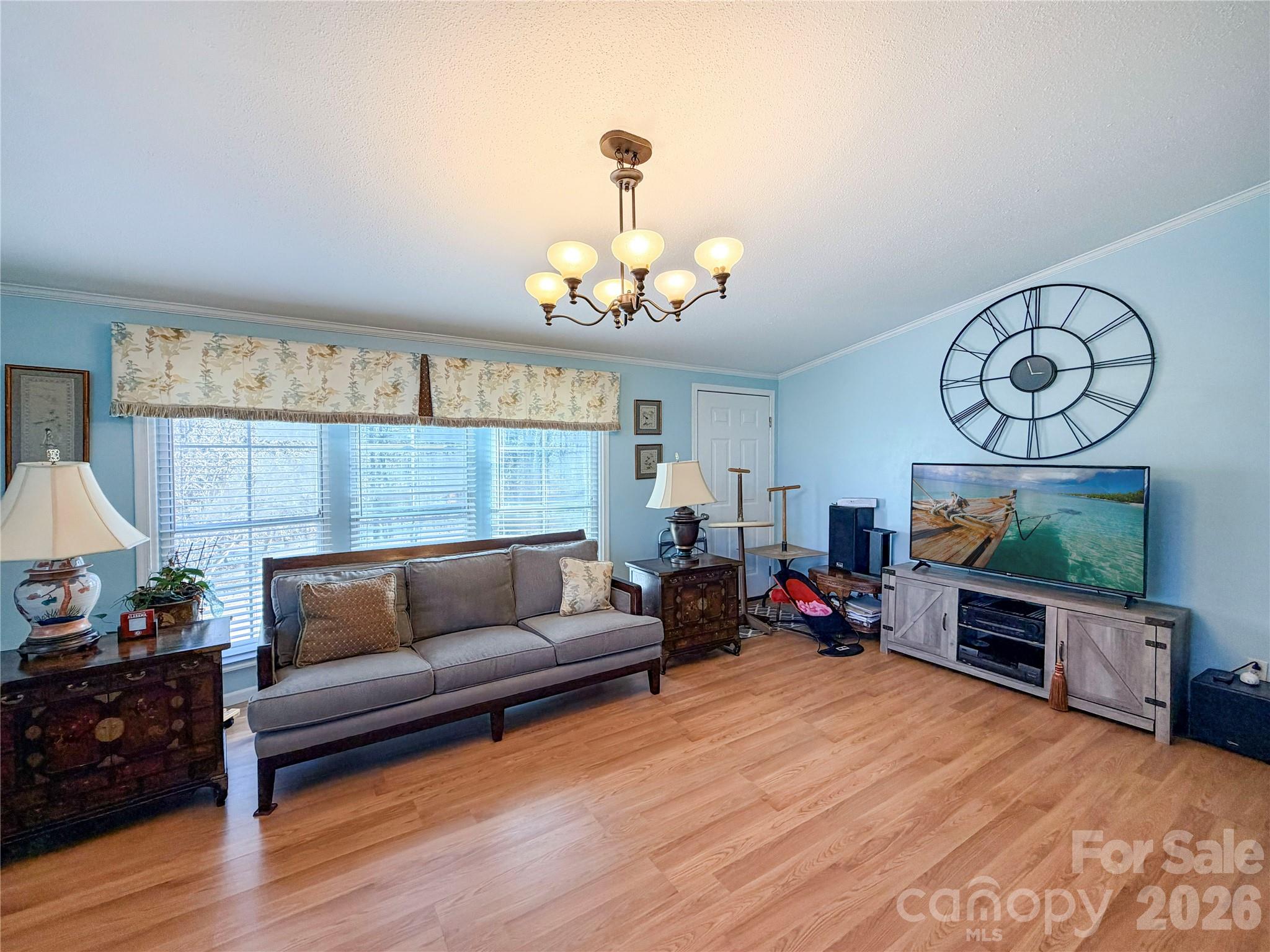 145 Goneaway Lane Cleveland, NC 27013 - Photo 4 of 12 a living room with furniture a fireplace and a chandelier