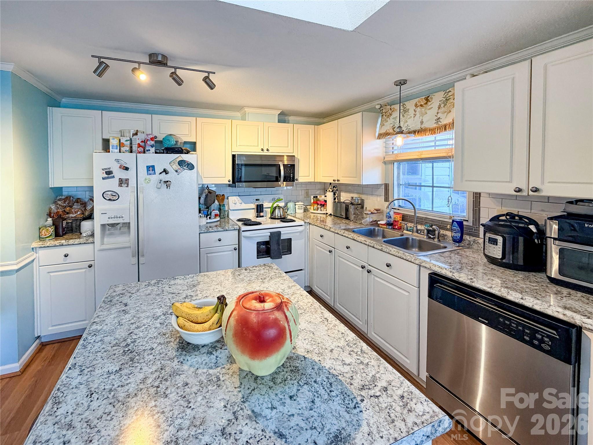 145 Goneaway Lane Cleveland, NC 27013 - Photo 6 of 12 a open kitchen with stainless steel appliances granite countertop a sink dishwasher stove refrigerator and microwave with cabinets