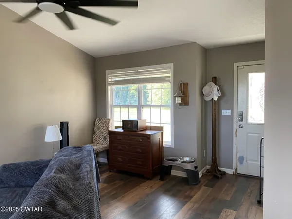 a living room with furniture and wooden floor