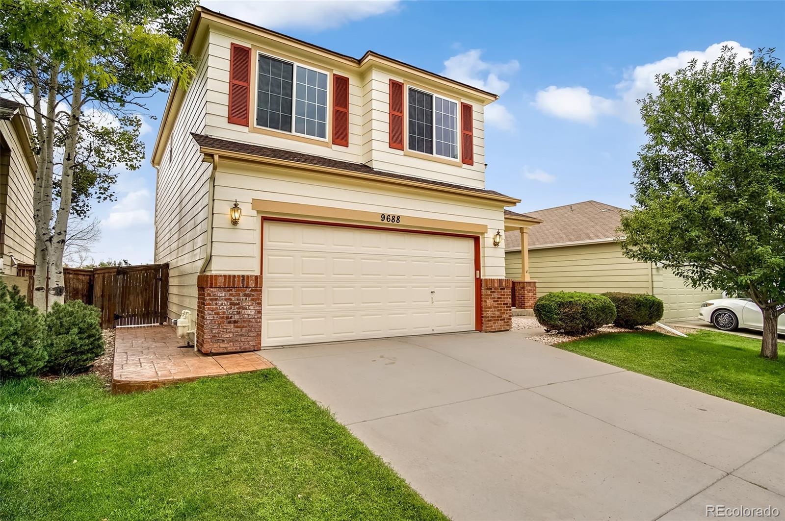 9688 Queenscliffe Drive Highlands Ranch, CO 80130 - Photo 1 of 34 a view of a house with a yard and garage