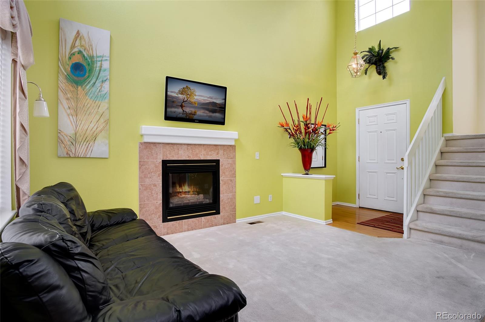 9688 Queenscliffe Drive Highlands Ranch, CO 80130 - Photo 12 of 34 a living room with furniture and a fireplace