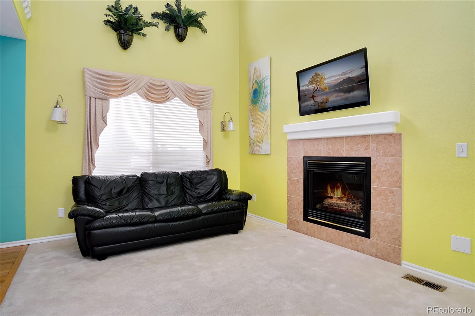 9688 Queenscliffe Drive Highlands Ranch, CO 80130 - Photo 19 of 34 a living room with furniture and a fireplace