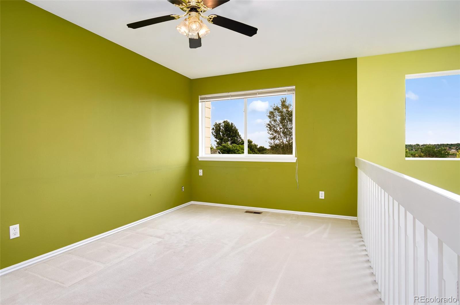 9688 Queenscliffe Drive Highlands Ranch, CO 80130 - Photo 20 of 34 a view of a room with a window and a ceiling fan
