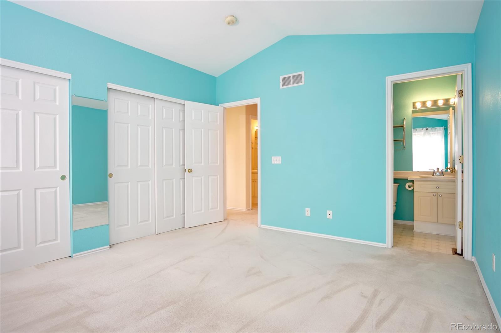 9688 Queenscliffe Drive Highlands Ranch, CO 80130 - Photo 23 of 34 an empty room with closet and a bathroom