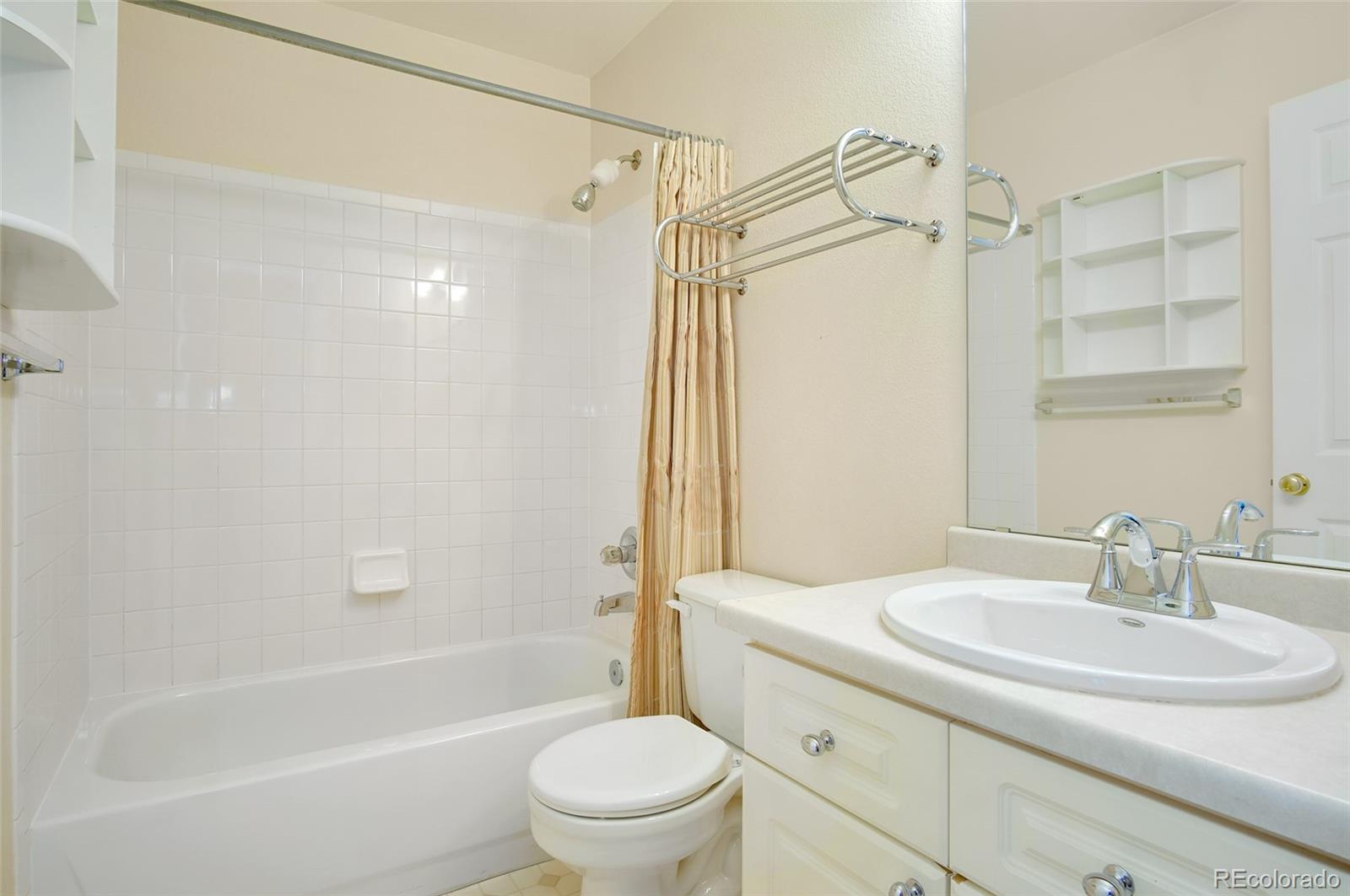 9688 Queenscliffe Drive Highlands Ranch, CO 80130 - Photo 25 of 34 a bathroom with a sink toilet and shower
