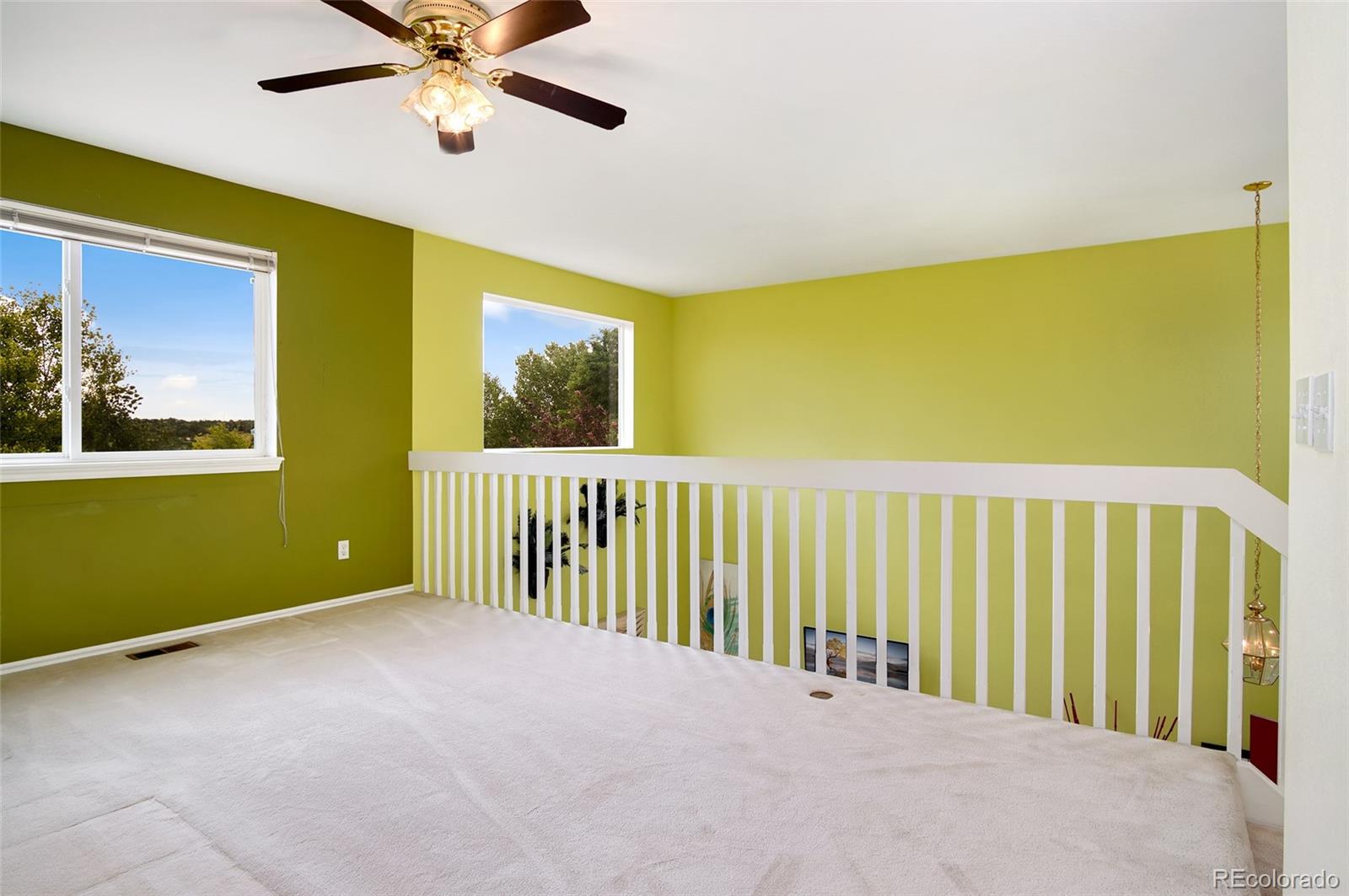 9688 Queenscliffe Drive Highlands Ranch, CO 80130 - Photo 29 of 34 a view of a room with a window and a ceiling fan