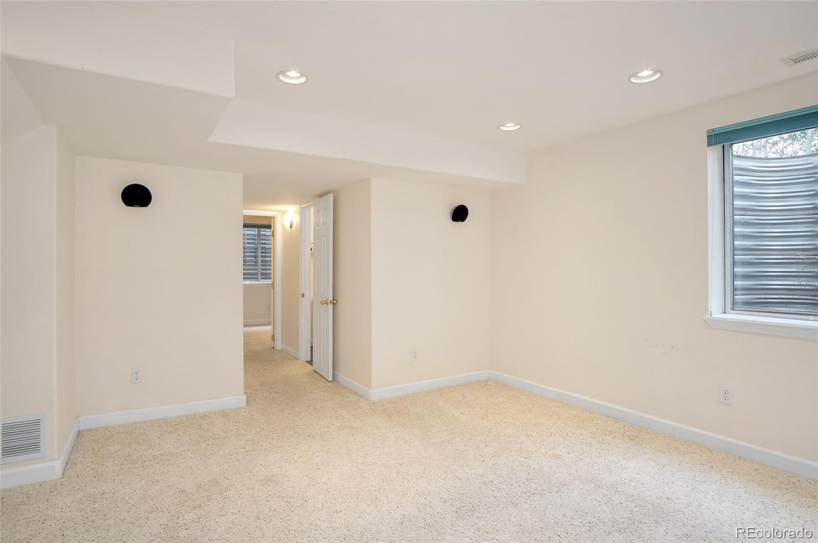 9688 Queenscliffe Drive Highlands Ranch, CO 80130 - Photo 7 of 34 wooden floor in an empty room with a window