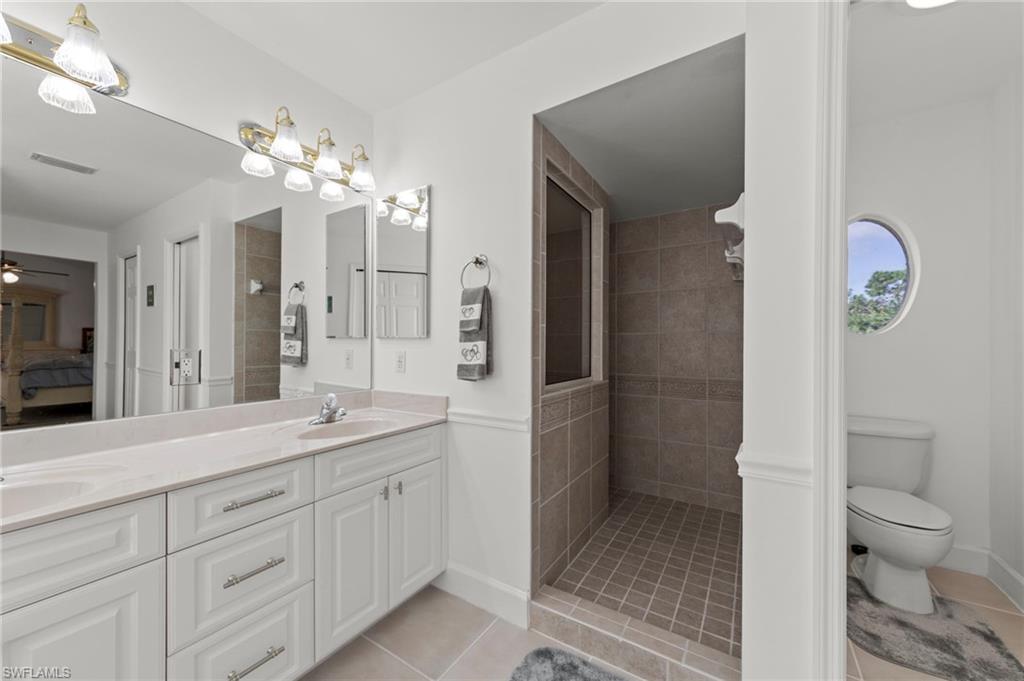 13541 Stringfellow Road Bokeelia, FL 33922 - Photo 15 of 49 a spacious bathroom with a granite countertop sink a toilet and a shower