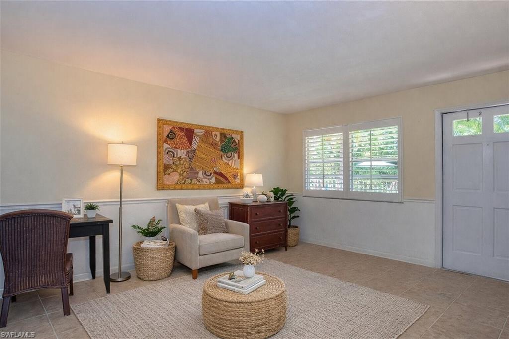 4290 Gulfstream Drive, Unit 5 Naples, FL 34112 - Photo 2 of 16 a living room with furniture and a large window