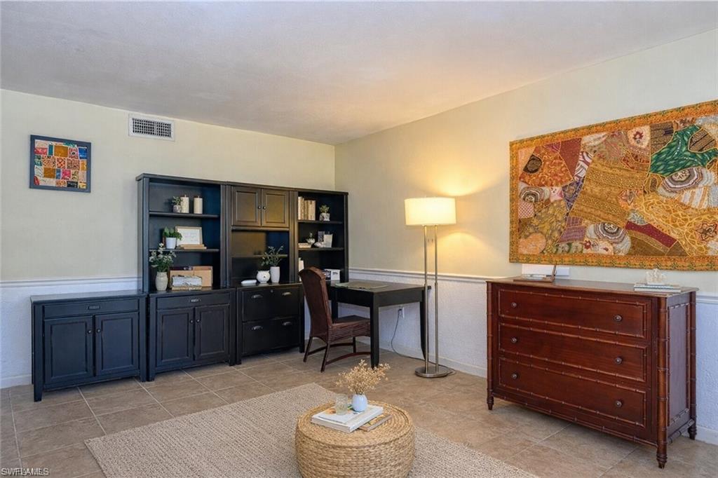 4290 Gulfstream Drive, Unit 5 Naples, FL 34112 - Photo 3 of 16 a living room with furniture and dresser