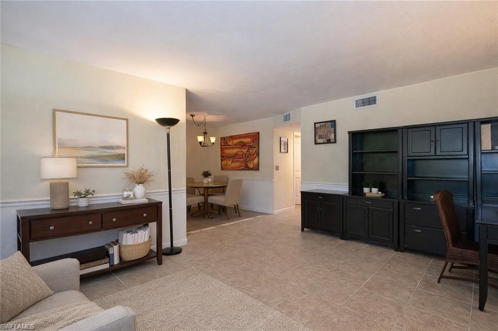 4290 Gulfstream Drive, Unit 5 Naples, FL 34112 - Photo 4 of 16 a room with a bed and furniture