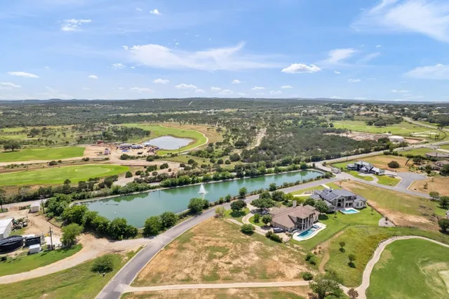 an aerial view of residential building with outdoor space lake view and ocean view