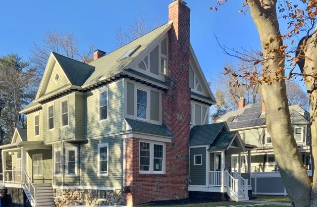 a front view of a residential apartment building with a yard