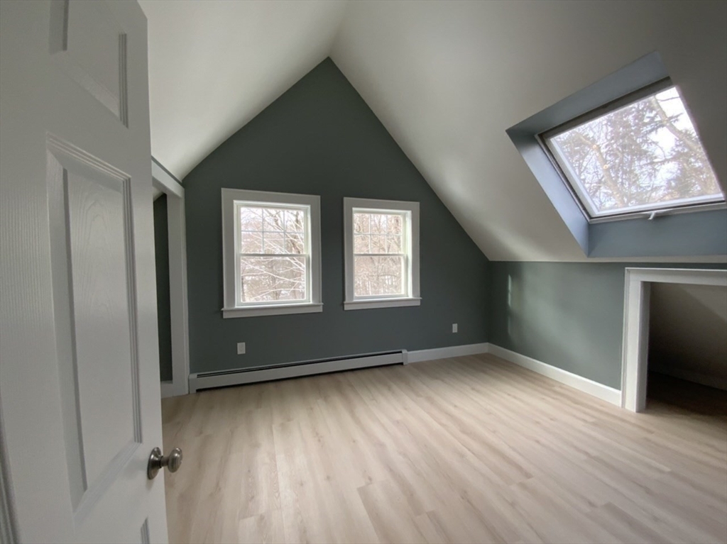 59 Beechmont Street Worcester, MA 01609 - Photo 30 of 39 a view of an empty room with wooden floor and a window