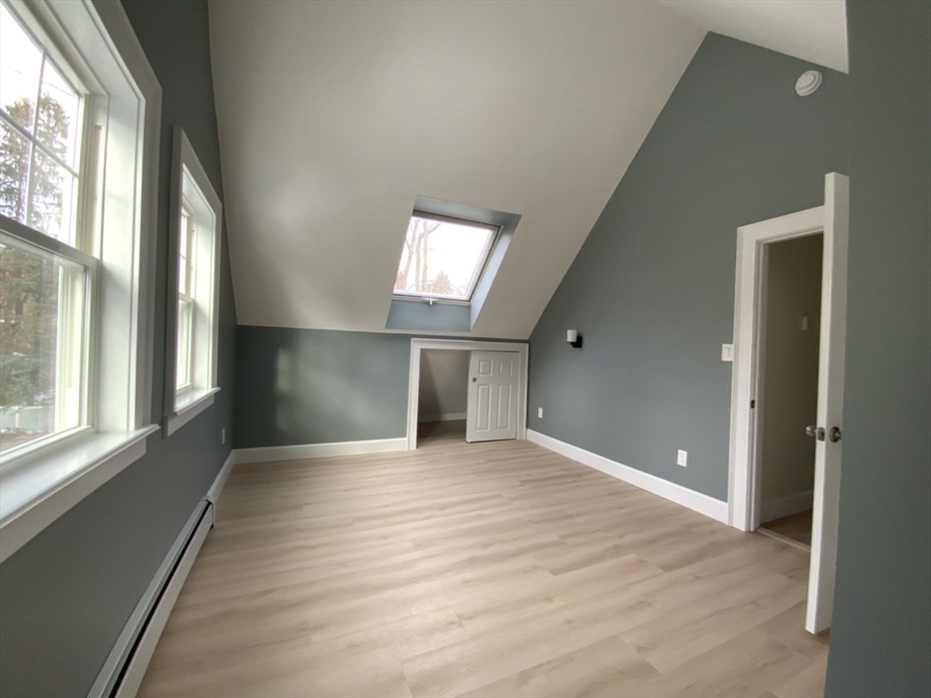 59 Beechmont Street Worcester, MA 01609 - Photo 31 of 39 a view of an empty room with glass door and a window