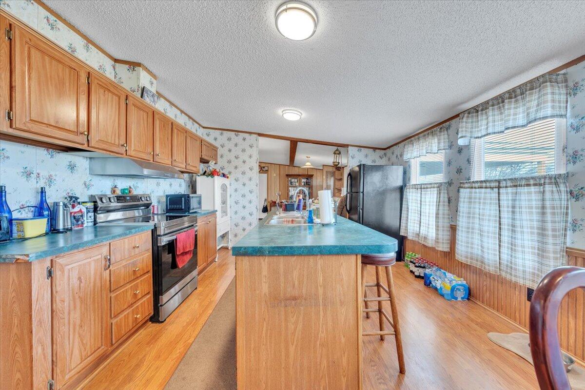 1421 Mob Creek Road Bedford, VA 24523 - Photo 14 of 44 a kitchen with stainless steel appliances granite countertop a stove a sink and a refrigerator