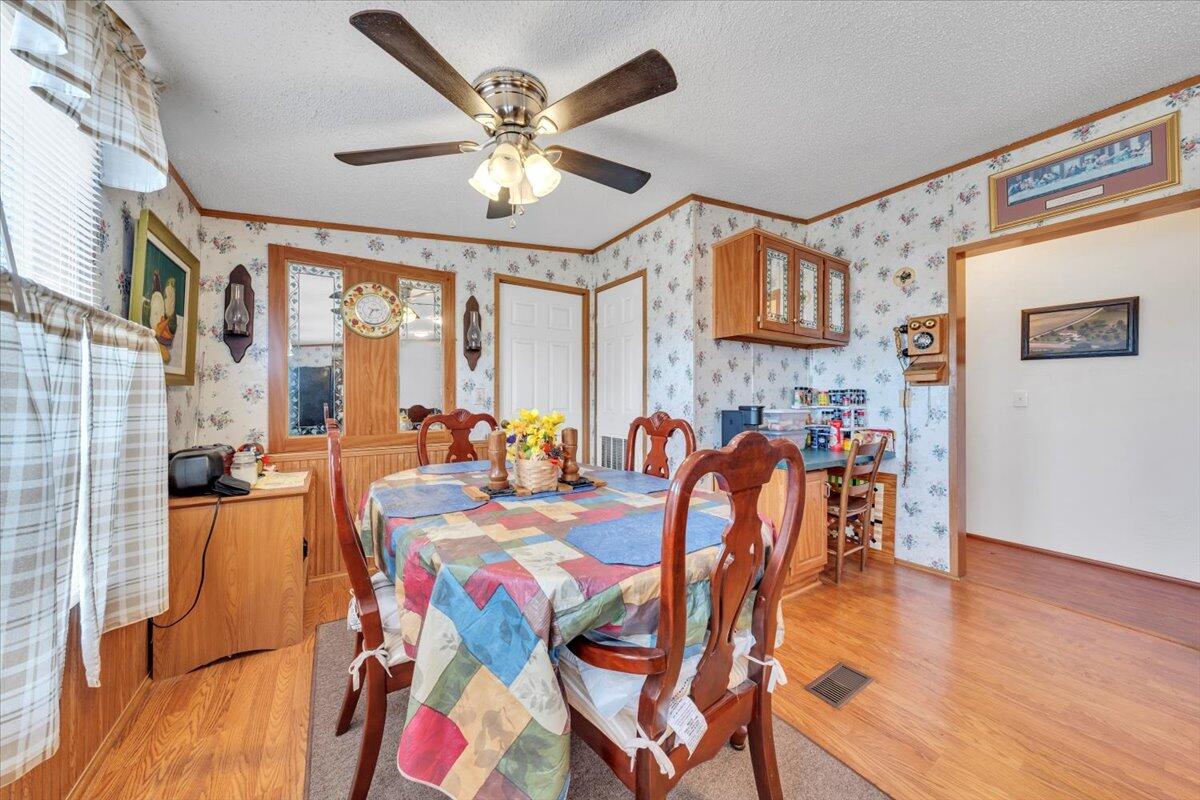 1421 Mob Creek Road Bedford, VA 24523 - Photo 16 of 44 a view of a dining room with furniture a chandelier and wooden floor