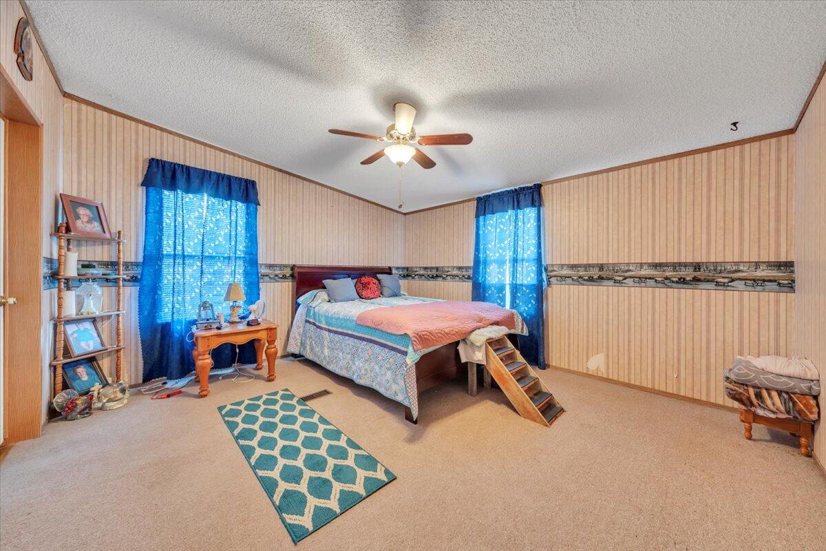 1421 Mob Creek Road Bedford, VA 24523 - Photo 18 of 44 a bedroom with a bed and a chandelier