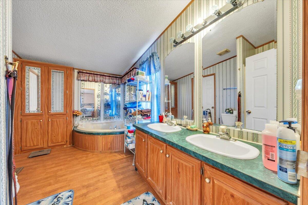 1421 Mob Creek Road Bedford, VA 24523 - Photo 20 of 44 a large bathroom with a granite countertop sink and a large mirror