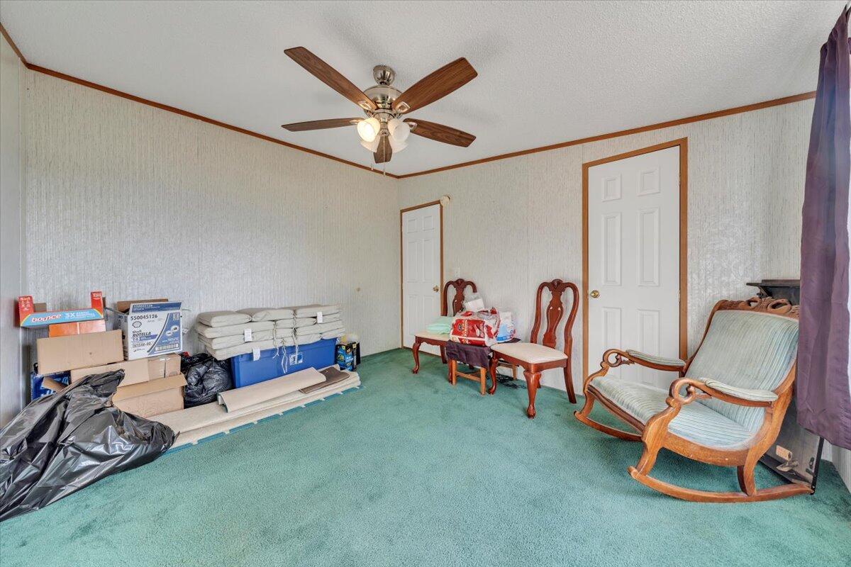 1421 Mob Creek Road Bedford, VA 24523 - Photo 24 of 44 a living room with furniture and a chandelier