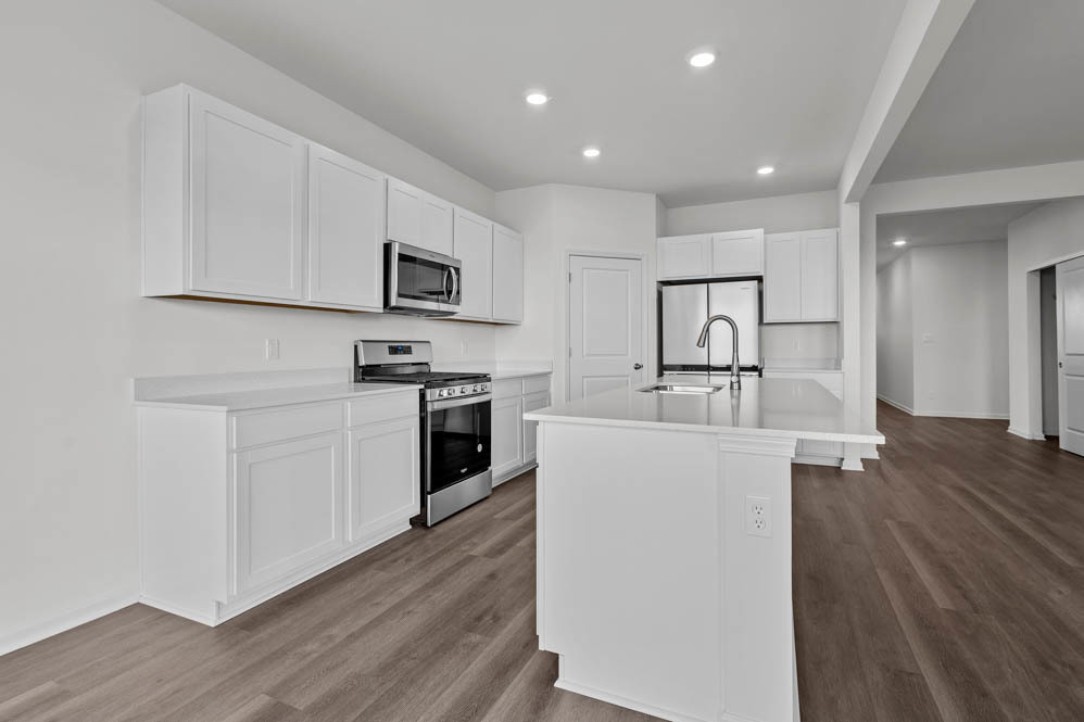 290 Snowdrop Lane Elgin, IL 60124 - Photo 17 of 30 a kitchen with stainless steel appliances a stove top oven a sink a refrigerator white cabinets and wooden floor
