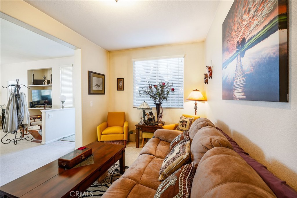 310 Sunset Way, Unit 5 Oceanside, CA 92058 - Photo 11 of 41 a living room with furniture and a flat screen tv
