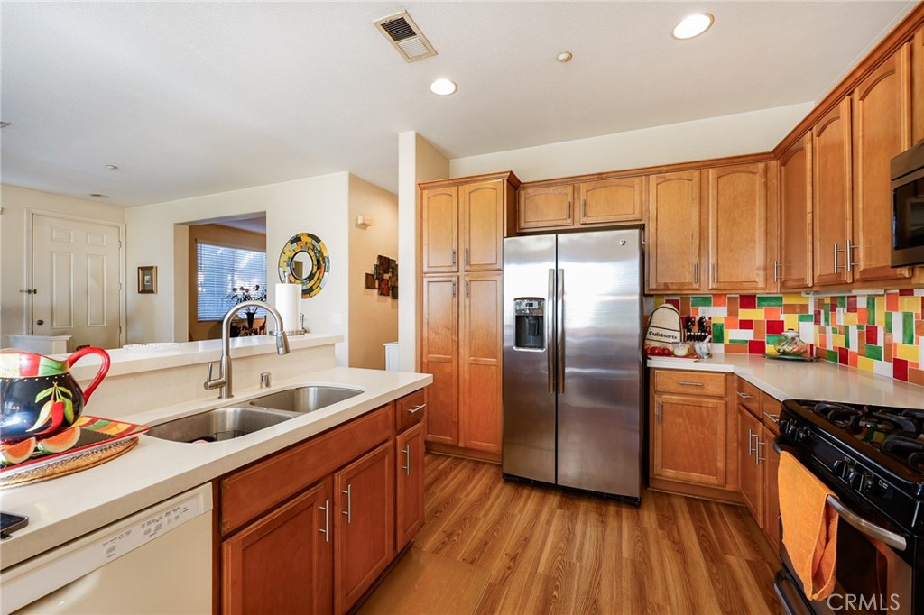 310 Sunset Way, Unit 5 Oceanside, CA 92058 - Photo 12 of 41 a kitchen with stainless steel appliances granite countertop a sink stove and refrigerator