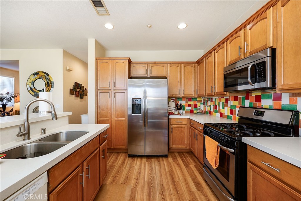 310 Sunset Way, Unit 5 Oceanside, CA 92058 - Photo 13 of 41 a kitchen with stainless steel appliances granite countertop a sink refrigerator and cabinets