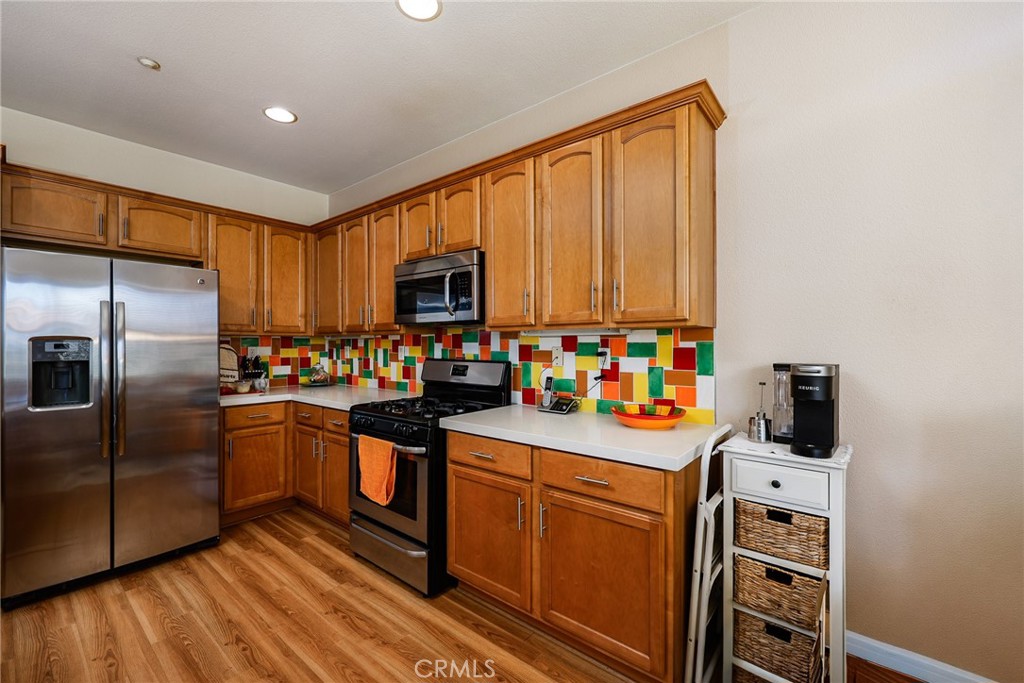 310 Sunset Way, Unit 5 Oceanside, CA 92058 - Photo 14 of 41 a kitchen with stainless steel appliances a stove refrigerator sink and microwave