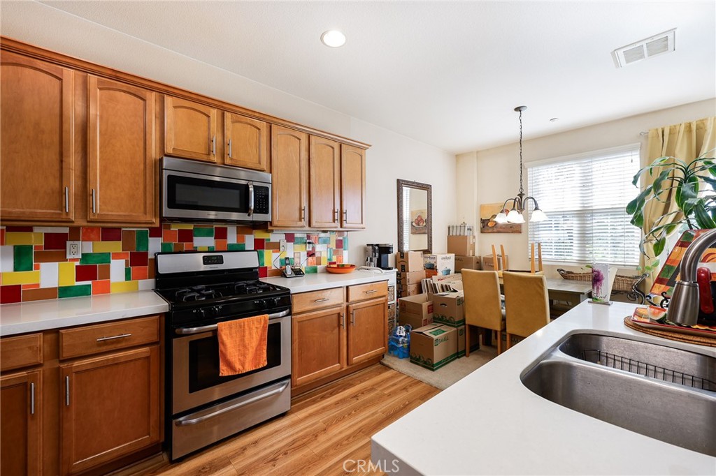 310 Sunset Way, Unit 5 Oceanside, CA 92058 - Photo 15 of 41 a kitchen that has a sink and a stove top oven
