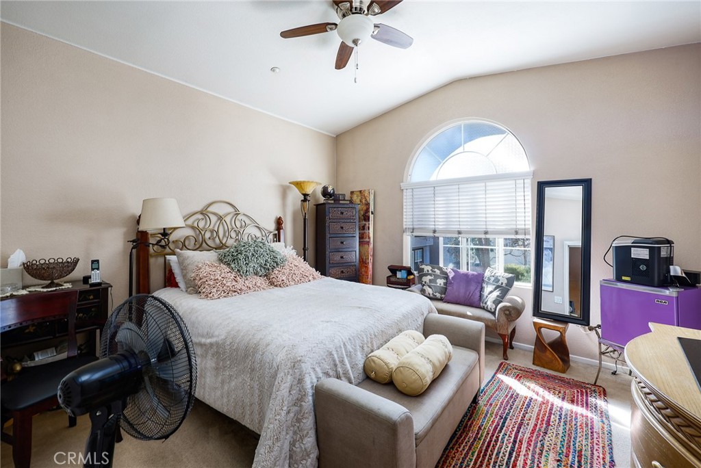 310 Sunset Way, Unit 5 Oceanside, CA 92058 - Photo 24 of 41 a bedroom with a bed and a chandelier