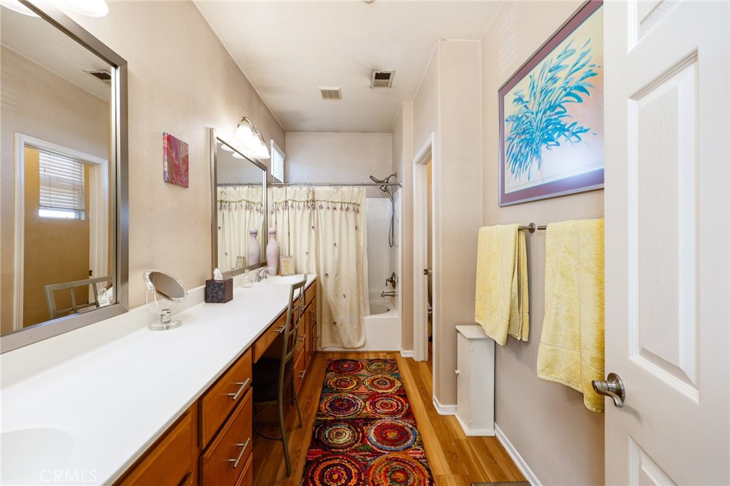 310 Sunset Way, Unit 5 Oceanside, CA 92058 - Photo 27 of 41 a bathroom with a double vanity sink and a mirror