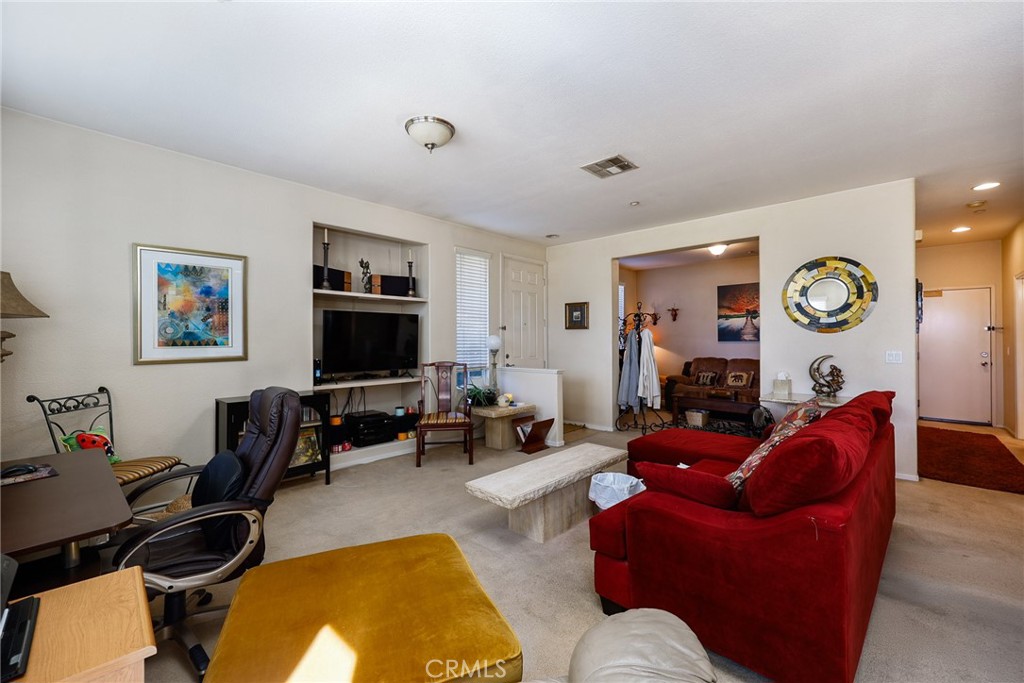 310 Sunset Way, Unit 5 Oceanside, CA 92058 - Photo 8 of 41 a living room with furniture and a flat screen tv