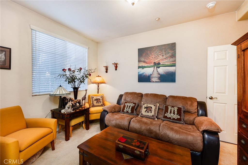 310 Sunset Way, Unit 5 Oceanside, CA 92058 - Photo 9 of 41 a living room with furniture and a potted plant