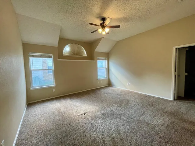 a view of a livingroom with a chandelier fan and a fireplace