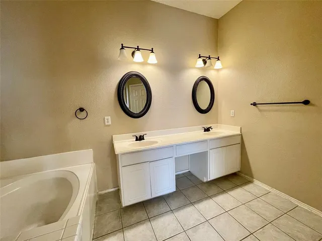 a bathroom with a double vanity sink mirror and toilet