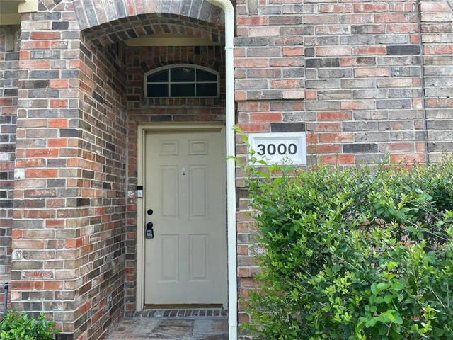 a front view of a building with garden