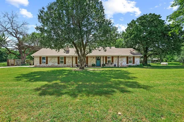 a front view of house with yard and green space
