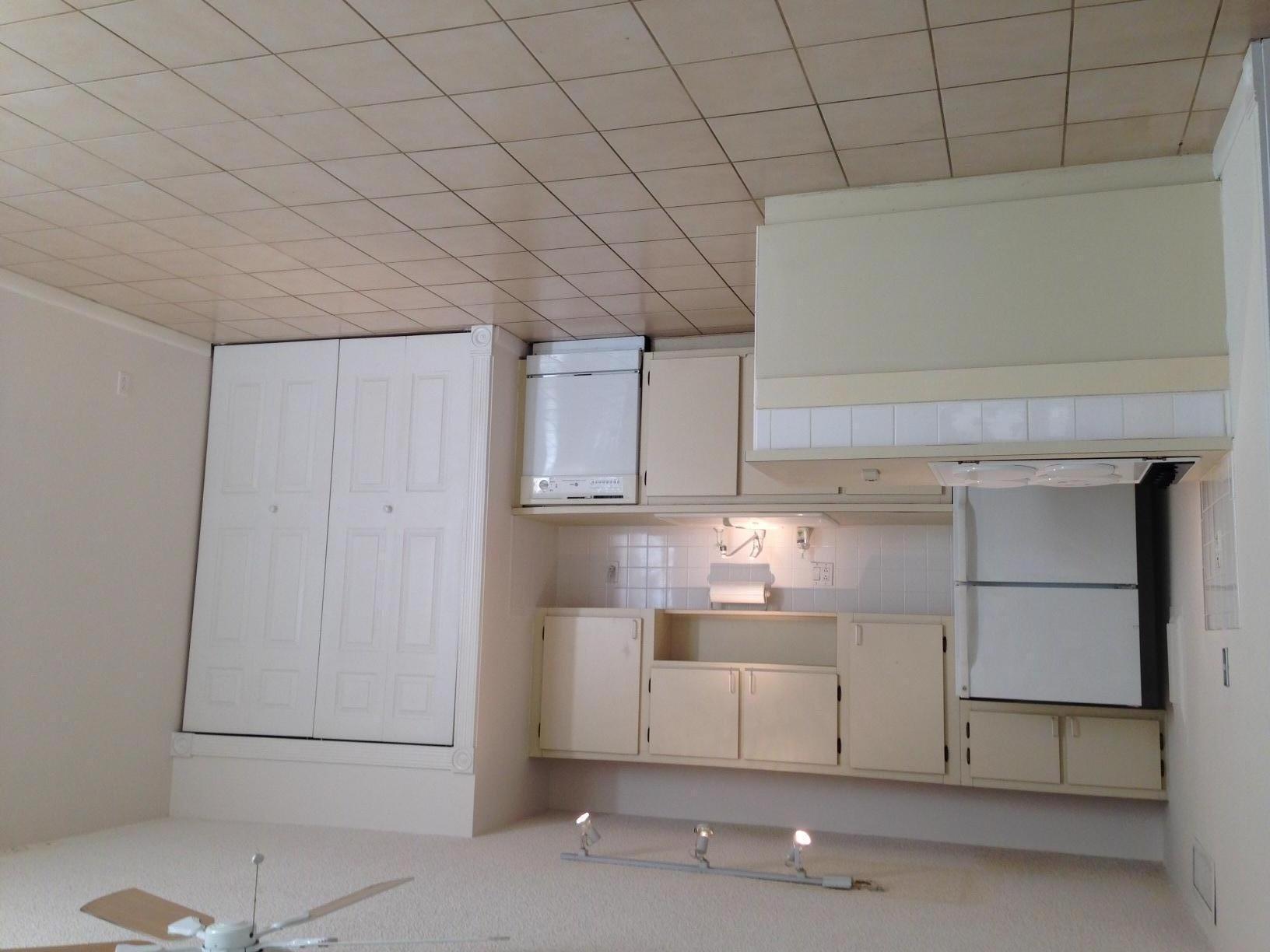 a kitchen with white cabinets and white appliances