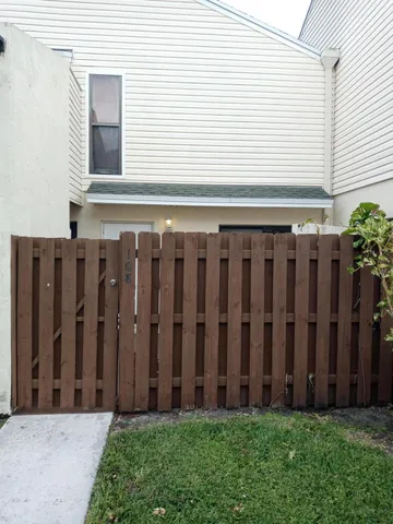 a view of a backyard with wooden fence