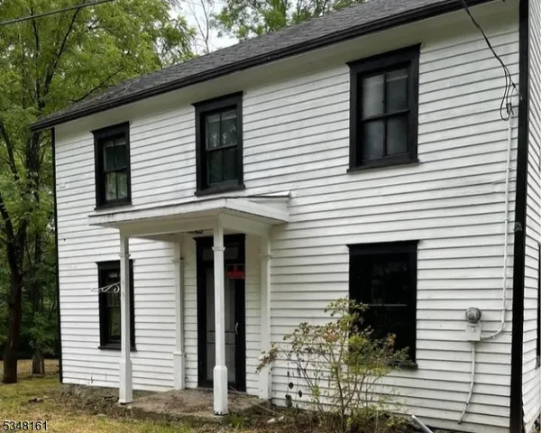 a view of a white house with many windows