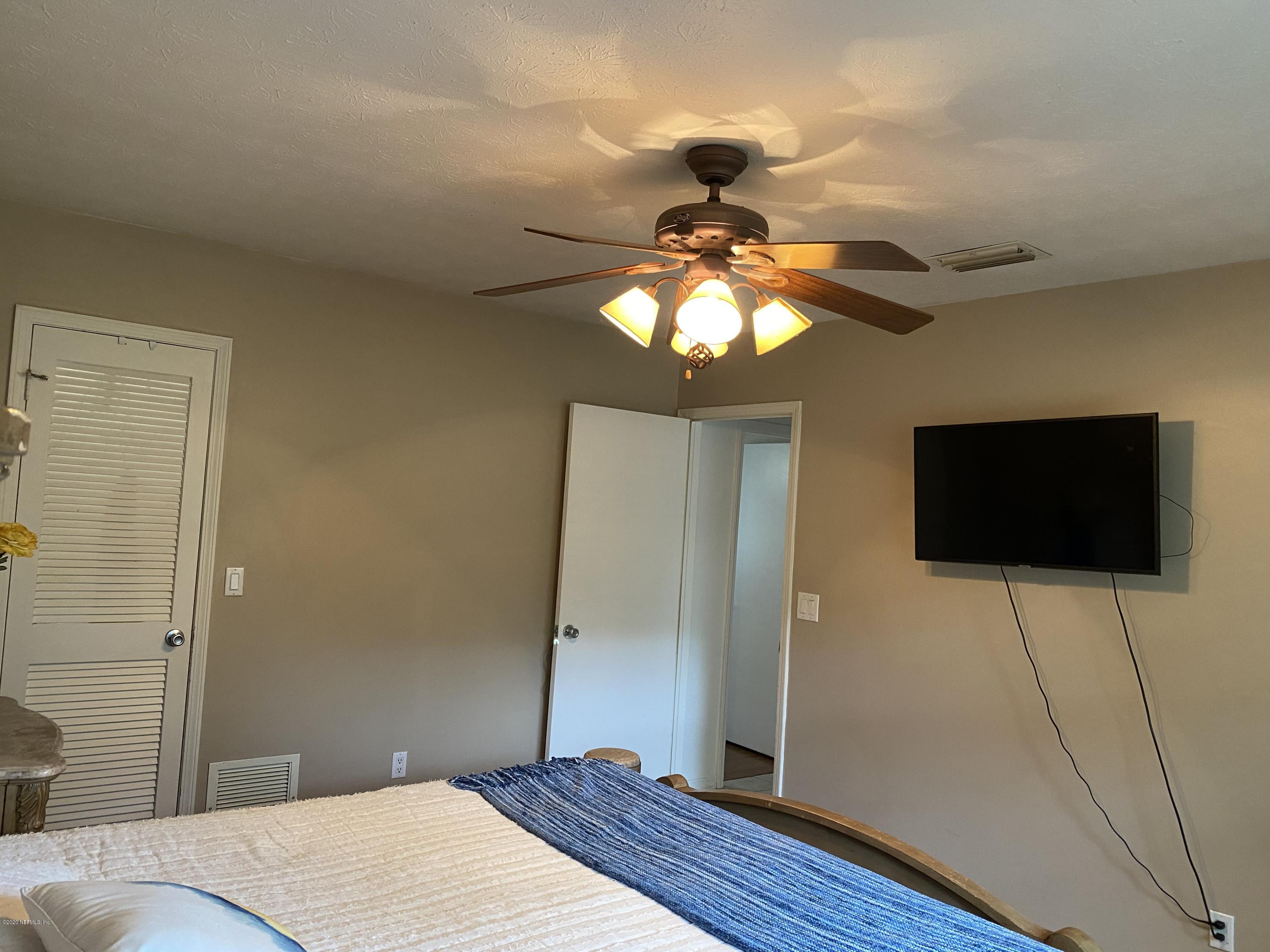 8828 San Rae Road Jacksonville, FL 32257 - Photo 10 of 21 a bedroom with a bed and a flat screen tv
