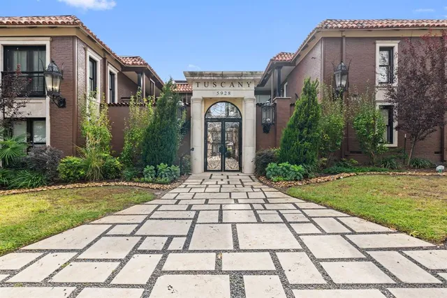 a view of a brick house with a yard