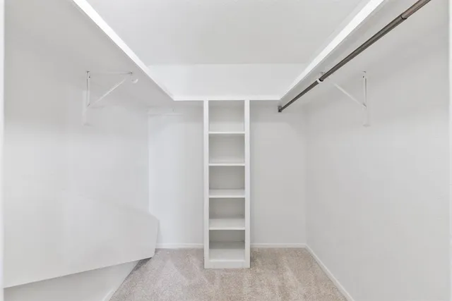 a bathroom with a granite countertop sink a toilet a mirror a bathtub and shower