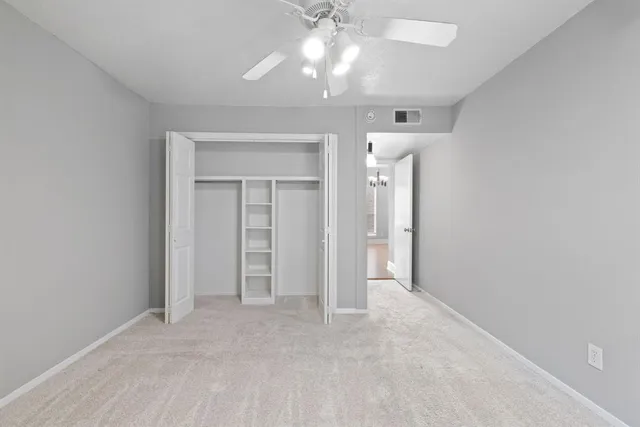 a view of a patio with dining table and chairs under an umbrella